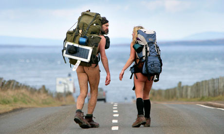 Naked people walking down a road